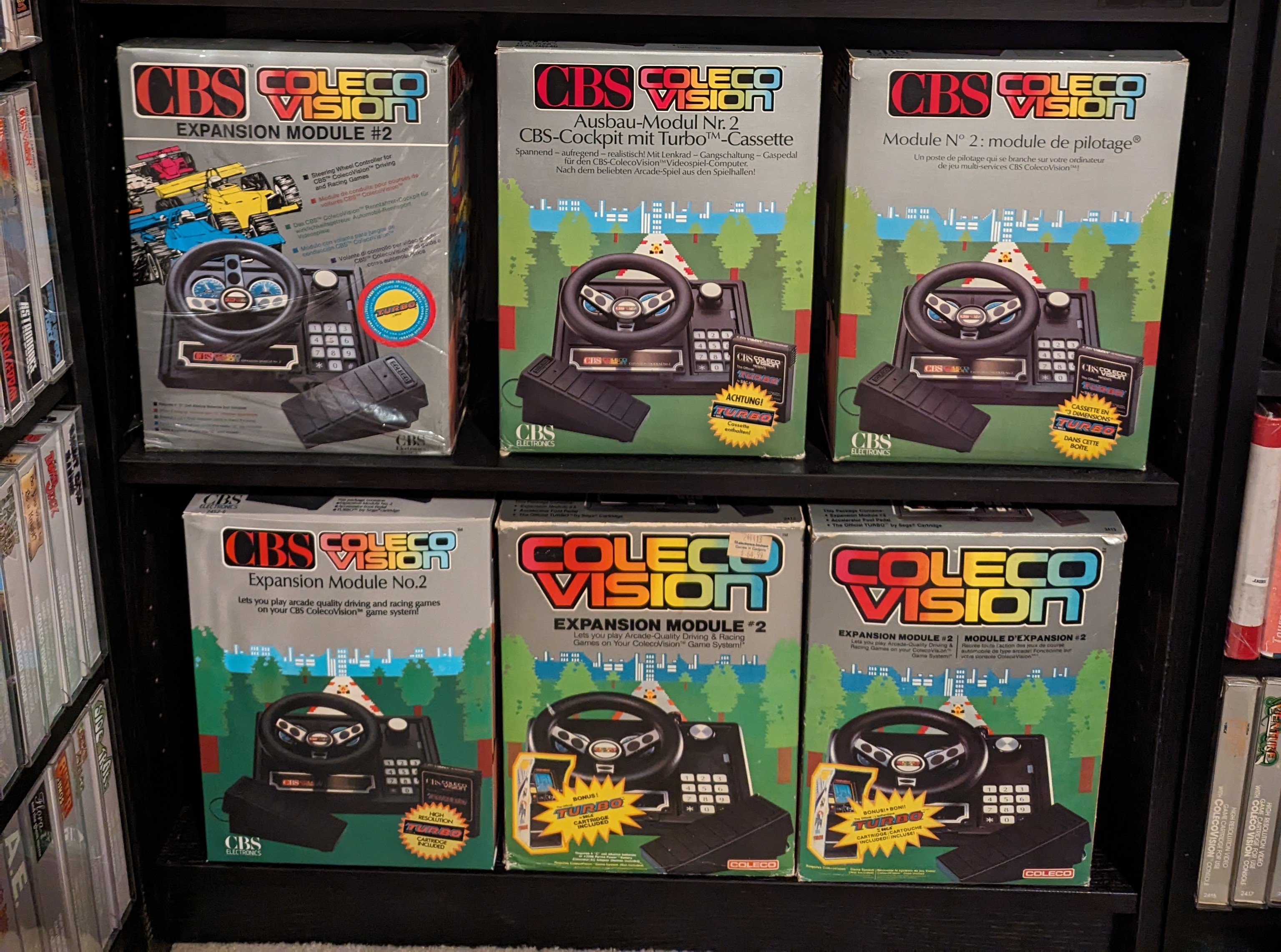 ColecoVision Expansion Module #2 collection showing driving controller variants with steering wheel and gas pedal